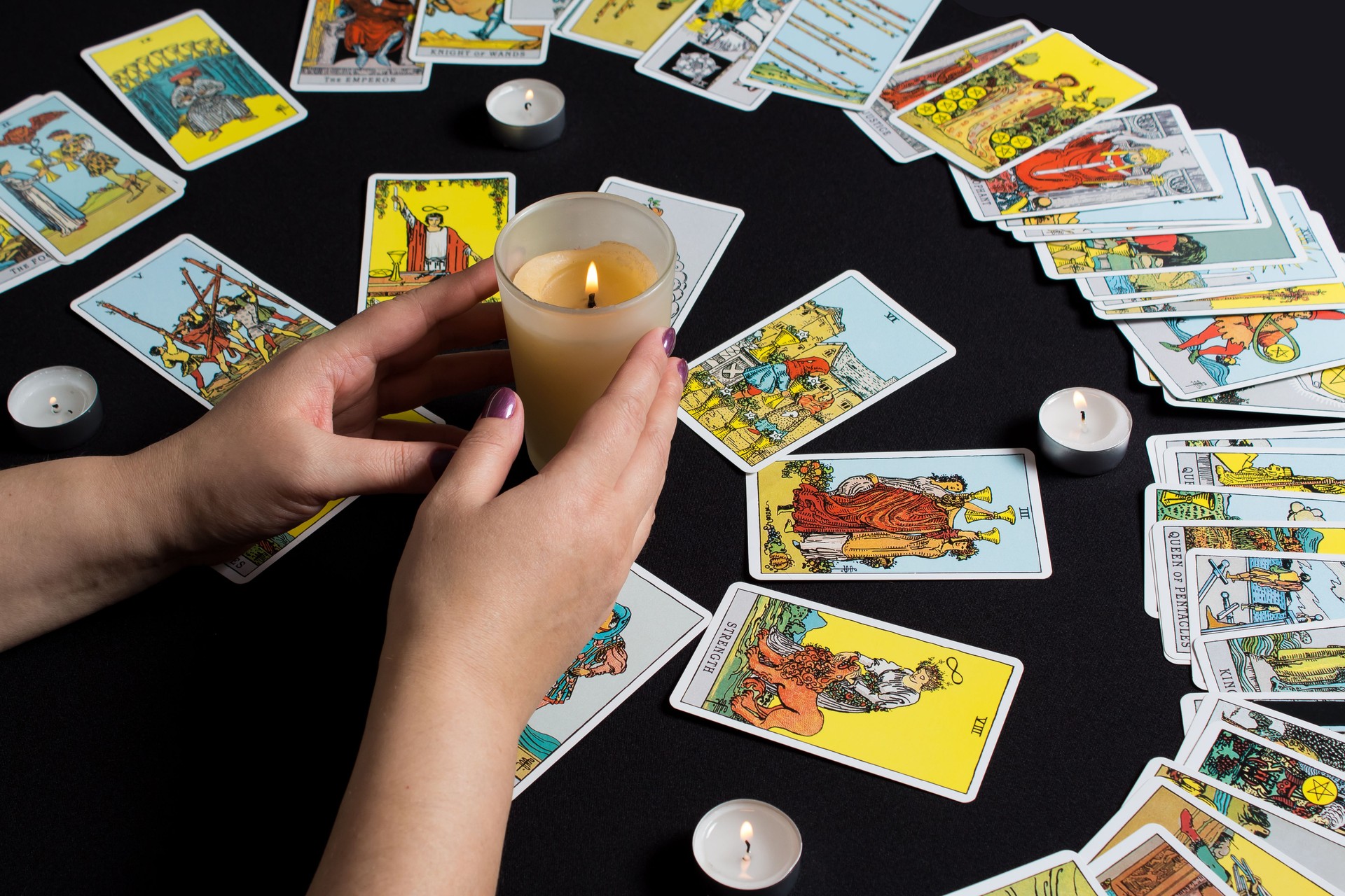 Bangkok,Thailand,november.22.19. Gypsy lays out Tarot cards and wonders for the future. Christmas fortune telling and fortune telling. Magical sessions with the cards. Women's hands and Tarot cards.